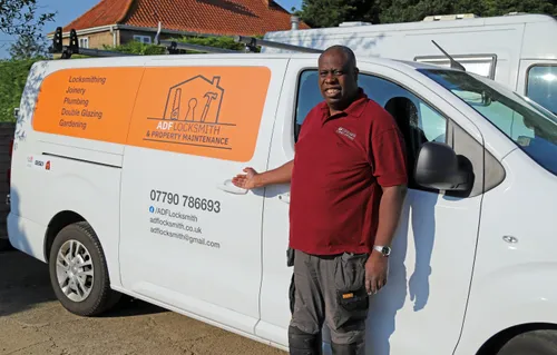 Andrew Fisher posing next to his ADF Locksmith maintenance van